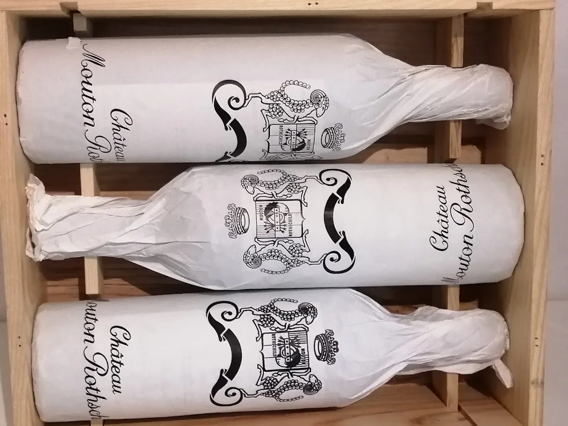 2026-04-19に酒井 浩（プラチナワイン代表）が撮影した、木箱に収められた保護紙付きのムートン・ロートシルト 2005年。